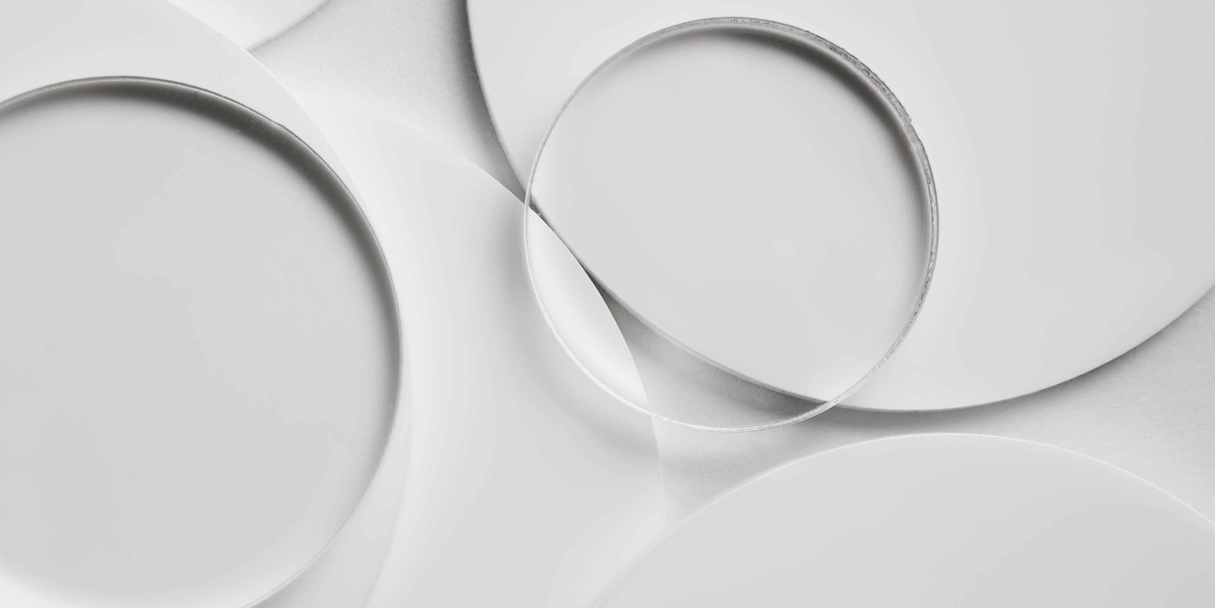 Clear round glass plates on white plates